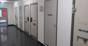 Image of Reception corridor with closed holding cell doors at Eastern Goldfields Regional Prison