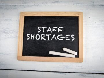 Image of a chalkboard with words "Staff Shortages' written in chalk on the board.